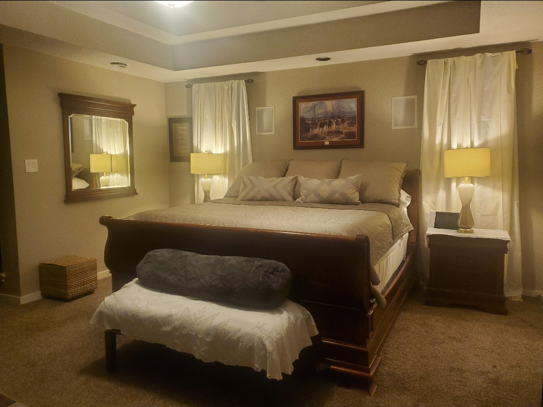 Pristinely made king bed in a serene primary suite
