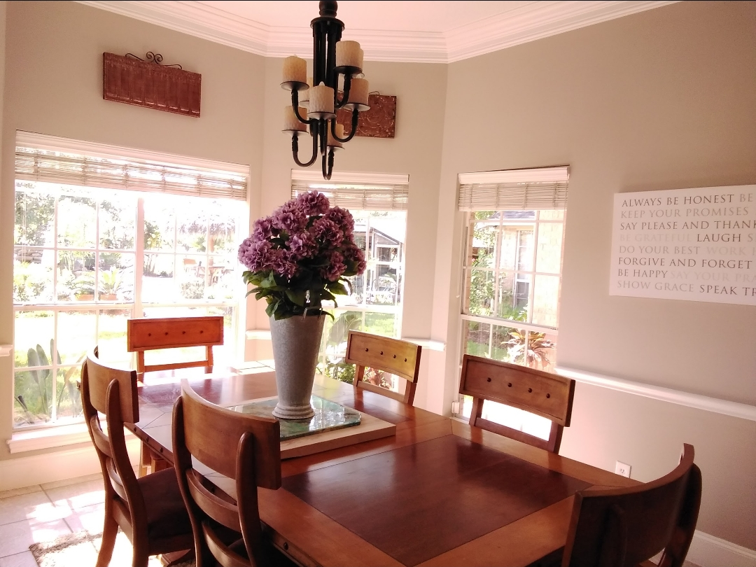 Bright dining room with polished table and styled centerpiece
